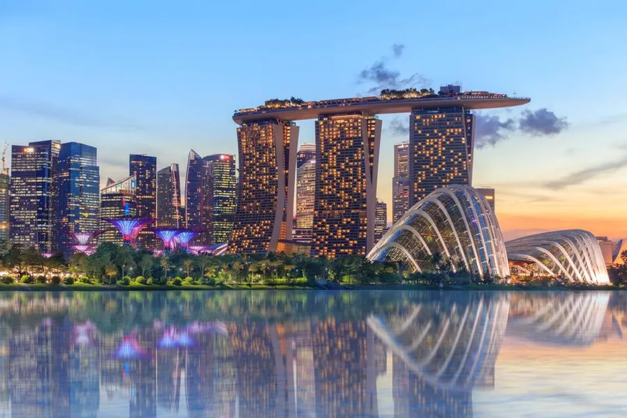 Richest country in Asia 2026 – Singapore skyline with Marina Bay Sands and financial district at night symbolizing wealth and innovation