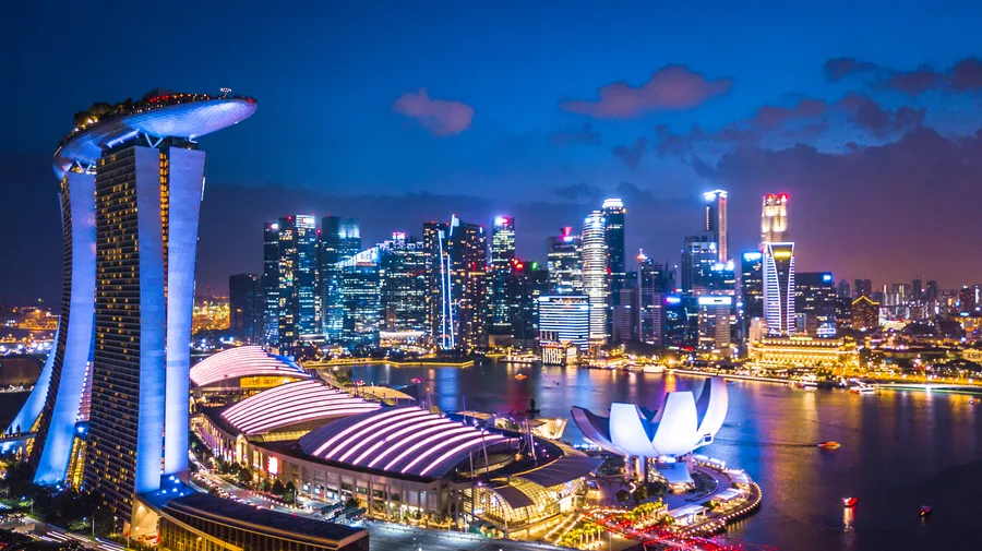 Richest country in East Asia 2026 – Singapore Marina Bay Sands and financial district skyline at night symbolizing wealth and innovation